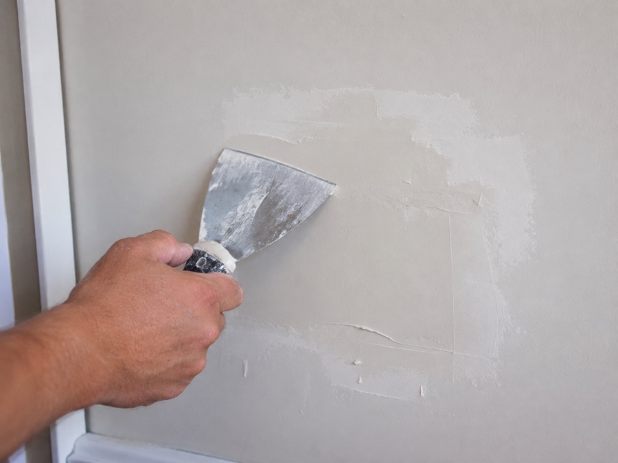 Applying joint compound to patch a drywall section