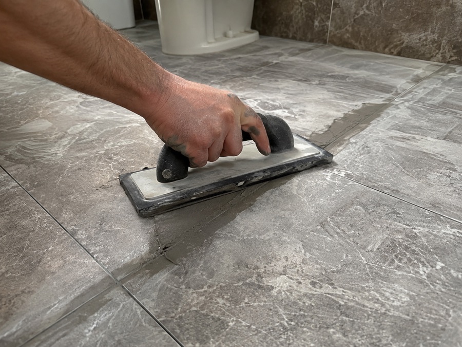 Regrouting a bathroom floor tile joint