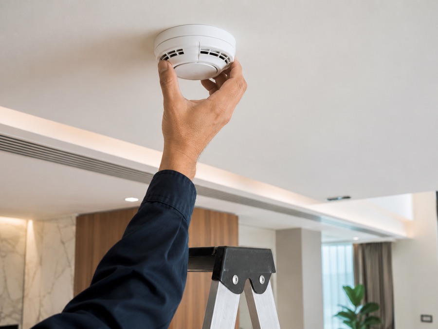 Installing a smoke detector on a ceiling