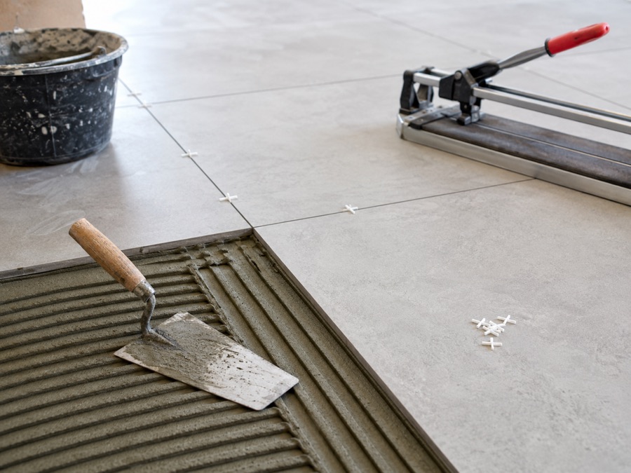 Tile installation tools and freshly laid porcelain flooring