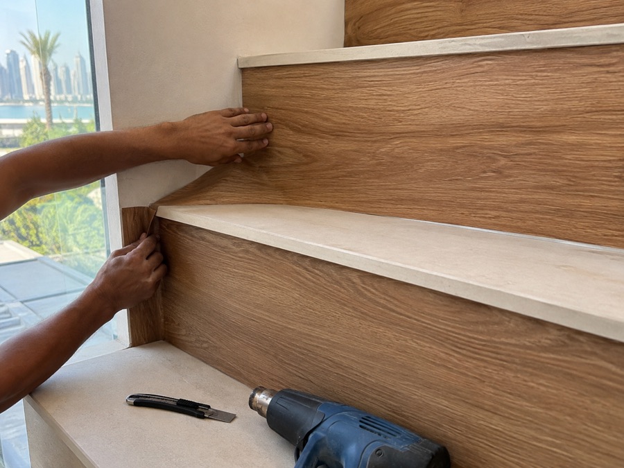 Applying warm-oak wood-grain vinyl to a staircase riser